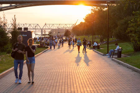 Novosibirsk, Russia - 07/12/2020: Mikhailovskaya embankment at sunset of a summer day at golden hour with a lot of lakes on a walk during the weekend.のeditorial素材