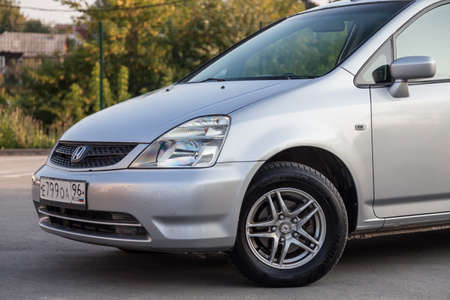 Novosibirsk, Russia - 08.05.20: Front bumper and hood view of a Honda Stream car in a silver body...