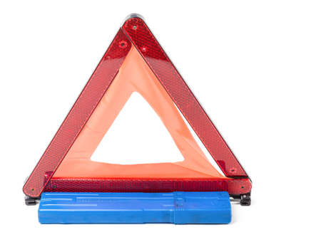 Warning stop sign made of red reflective plastic with a blue case on a white isolated background in...