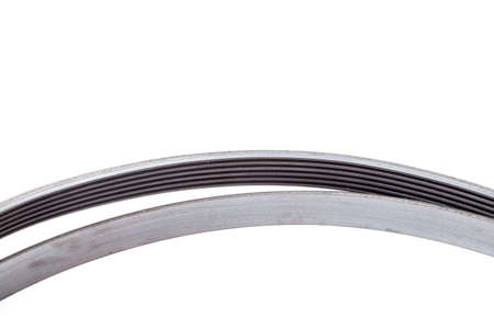 Part of an element of a poly-V-belt made of black rubber on a white isolated background of auto...