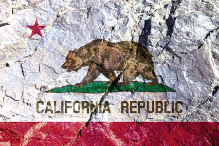 National flag of country America State of California against background of mountain wall with crack and faults on Independence Day painted brown bear on white. Political religious customs and deliveryの写真素材