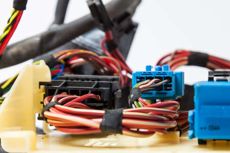 A cable of matted wires of different colors with connectors in the electrical wiring of the car. Internet line in the work of the provider.の写真素材