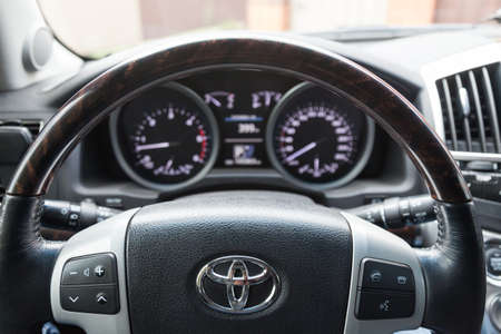 Novosibirsk, Russia - 09.26.2020: View to the interior of Toyota Land Cruiser 200 with dashboard, clock, media system, front seats, gray leather and shift gear after cleaning before sale on parkingのeditorial素材