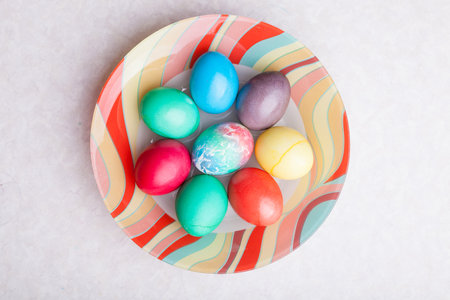 Easter holiday with colorful eggs on a plate while cooking. Homemade baking.の写真素材