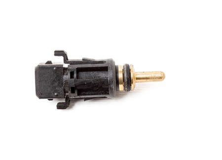Black coolant temperature sensor on a white background with yellow metal elements. The engine control unit corrective composition of the air-fuel mixture, the engine idle speed, the ignition timing.の写真素材