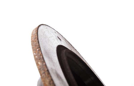 Old brake discs covered with rust on a white isolated background in a photography studio. Seasonal repair of suspension and brake system in workshop or sale of spare parts for auto analysis.の写真素材