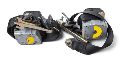 Spare part and interior element black seat belt from a car on a white isolated background. Auto...