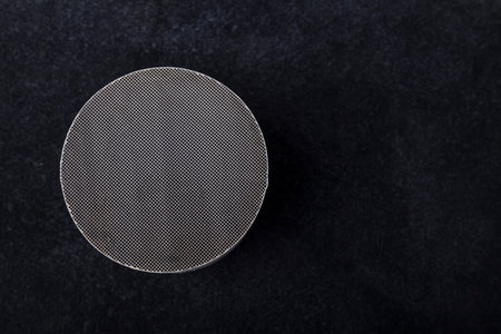 Macro shot of a metal strip catalyst made of heat-resistant chrome-nickel steel. Molten automotive...