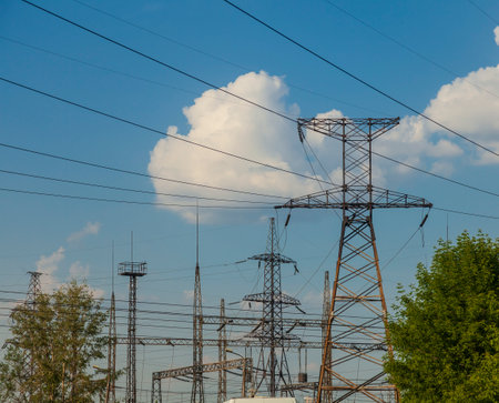 Towers with power lines along which wires are stretched with the transmission of electricity from power plants over long distances.の写真素材