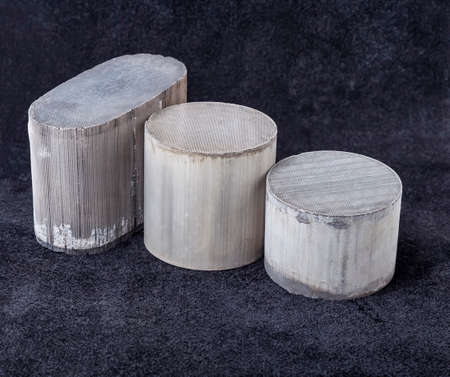 Three round and oval ceramic catalysts containing platinum, palladium and rhodium on a black...