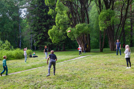 Novosibirsk, Russia - 06.19.2021: fun with friends. Full length of young people in casual wear playing while spending carefree time outdoorsのeditorial素材
