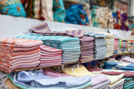Multicolored rolls of fabrics and textiles on the market. Sale of textiles on the Turkish market in Kermerの写真素材