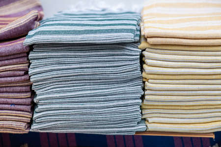 Multicolored rolls of fabrics and textiles on the market. Sale of textiles on the Turkish market in Kermerの写真素材