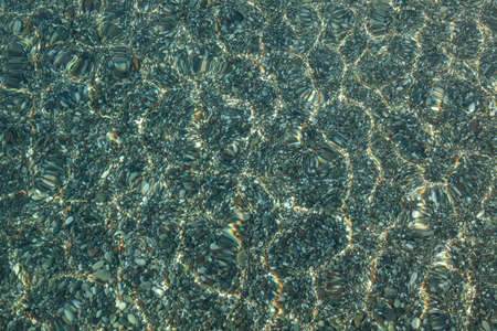 Sea bottom with pebbles through clear water. Turkey vacation.の写真素材