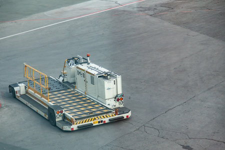 Kemer, Turkey - 08.28.2021: a tractor with a trailer for transporting passenger luggage between an...
