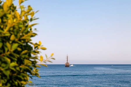 Vintage mast wooden sailing ship for sea tours. Touristic pirate ship in port. Marina in in resort city Kemer, Turkey. Old harbor in Turkey.の写真素材