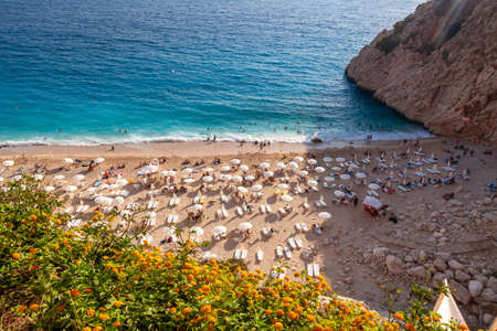 People Crowd Relaxing On Beach. Swimming people in sea. Top view of Kaputas Beach between Kas and Kalkan. The best beach in Turkey with turquoise waters, Mediterranean Seaの写真素材