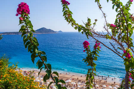 People Crowd Relaxing On Beach. Swimming people in sea. Top view of Kaputas Beach between Kas and...