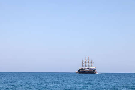 Vintage mast wooden sailing ship for sea tours. Touristic pirate ship in port. Marina in in resort city Kemer, Turkey. Old harbor in Turkey.の写真素材