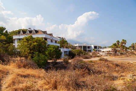 Abandoned building exterior view of Hotel in the Turkish village of kemer with broken windows and overgrown plants.のeditorial素材