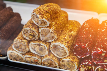 Popular Sweet turkish food - stacks of turkish delights with nuts made of fruits in the street market in turkeyの写真素材