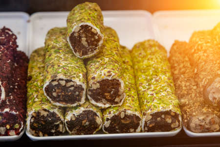 Popular Sweet turkish food - stacks of turkish delights with nuts made of fruits in the street market in turkeyの写真素材