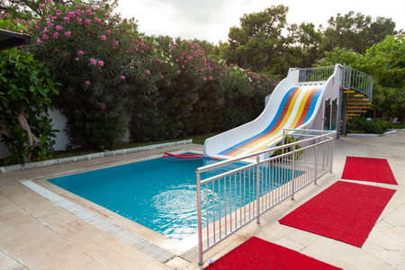 Swimming pool and little slides for children with water in hotel. Getting ready for new touristic...