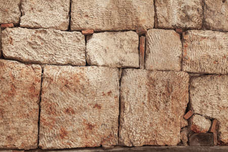 Stone wall texture background - gray stone siding with different sized stones