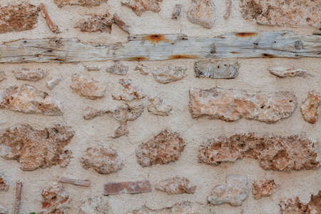 Stone wall texture background - gray stone siding with different sized stones