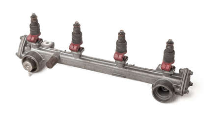 Close-up on a car fuel rail with injectors for supplying gasoline to a four cylinder engine on a...