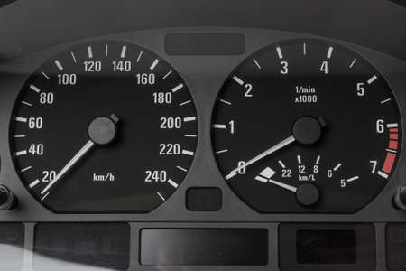 The dashboard of the car with white arrows with a speedometer, tachometer and other tools to monitor...