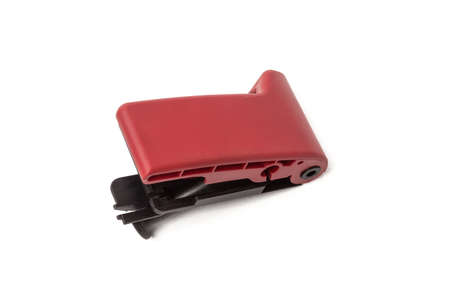 Close-up on a red plastic hood opening handle from a car interior on a white isolated background.