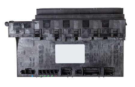 Plastic car engine control unit with metal elements on a white isolated background is the connecting...