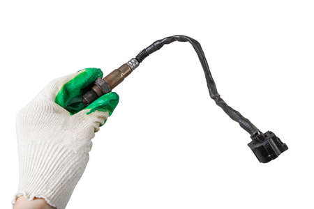 Lambda probe - oxygen sensor device designed to record the amount of remaining oxygen in the exhaust gas of car engine is located in exhaust system. Metal spare part for replacement to repair in workshopの写真素材