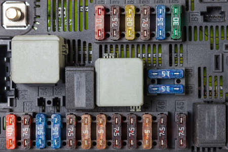 Automotive fuses on a black panel with holders and multi-colored markings - a protective device that opens the electrical circuit when the rated current in the circuit is exceeded. electrical repair.の写真素材