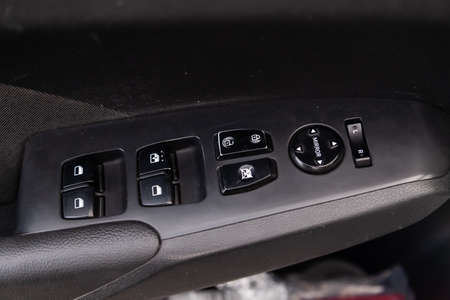 Close-up of the side door buttons: window adjustment buttons, door lock. Window control panel in a...