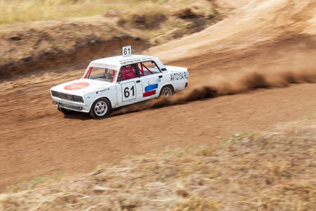 Novosibirsk, Russia - 08.07.2022: Rally off-road car make a turn with the clouds and splashes of sand, gravel and dust during rally championshipのeditorial素材