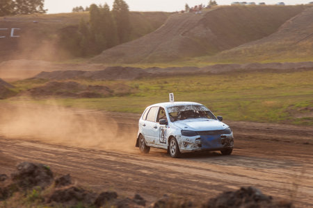 Novosibirsk, Russia - 08.07.2022: Rally off-road car make a turn with the clouds and splashes of...
