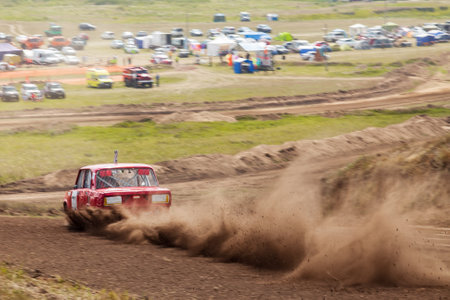 Novosibirsk, Russia - 08.07.2022: Rally off-road car make a turn with the clouds and splashes of sand, gravel and dust during rally championshipのeditorial素材