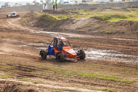 Novosibirsk, Russia - 08.07.2022: A small sports blurred buggy on a rally competition track during weekend training on a warm summer day.のeditorial素材