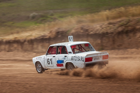 Novosibirsk, Russia - 08.07.2022: Rally off-road car make a turn with the clouds and splashes of sand, gravel and dust during rally championshipのeditorial素材