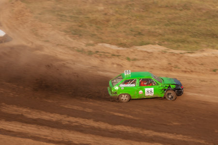 Novosibirsk, Russia - 08.07.2022: Rally off-road car make a turn with the clouds and splashes of sand, gravel and dust during rally championshipのeditorial素材