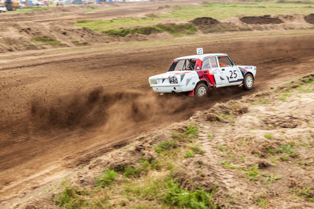 Novosibirsk, Russia - 08.07.2022: Rally off-road car make a turn with the clouds and splashes of sand, gravel and dust during rally championshipのeditorial素材