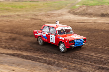 Novosibirsk, Russia - 08.07.2022: Rally off-road car make a turn with the clouds and splashes of sand, gravel and dust during rally championshipのeditorial素材
