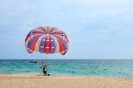 Beautiful Surin beach in Choeng Thale city, Phuket, Thailand with colorful parachute white sand, turquoise water and palm treesの写真素材