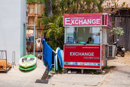 Thailand, Nai Harn beach - 03.30.23: Red currency exchange office in thailand near the beach to exchange money for thai baht.のeditorial素材