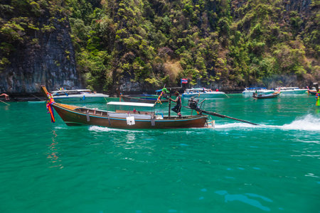 Thailand, Phuket - 04.01.23: A picturesque beautiful place on the island of Phi Phi Leh - Pi Leh Lagoon is popular for excursions with tourists on traditional Thai fishing boats. island travel in thailand.のeditorial素材