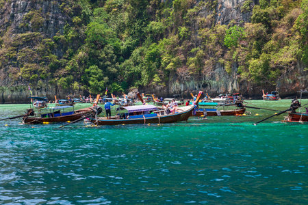 Thailand, Phuket - 04.01.23: A picturesque beautiful place on the island of Phi Phi Leh - Pi Leh Lagoon is popular for excursions with tourists on traditional Thai fishing boats. island travel in thailand.のeditorial素材
