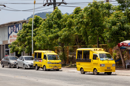 Thailand, Patong - 03.27.23: small Japanese trucks converted into taxis for tourists called tuk tuk in Thailand on the island of Phuket. Multi-colored cars on the streets of the city.のeditorial素材