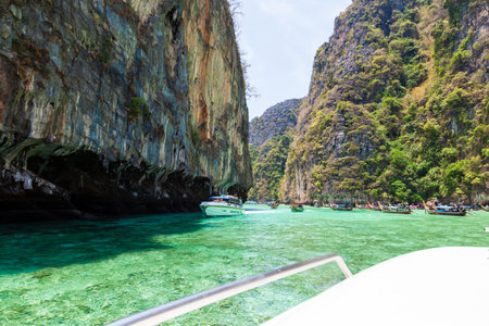 Thailand, Phuket - 04.01.23: A picturesque beautiful place on the island of Phi Phi Leh - Pi Leh Lagoon is popular for excursions with tourists on traditional Thai fishing boats. island travel in thailand.のeditorial素材
